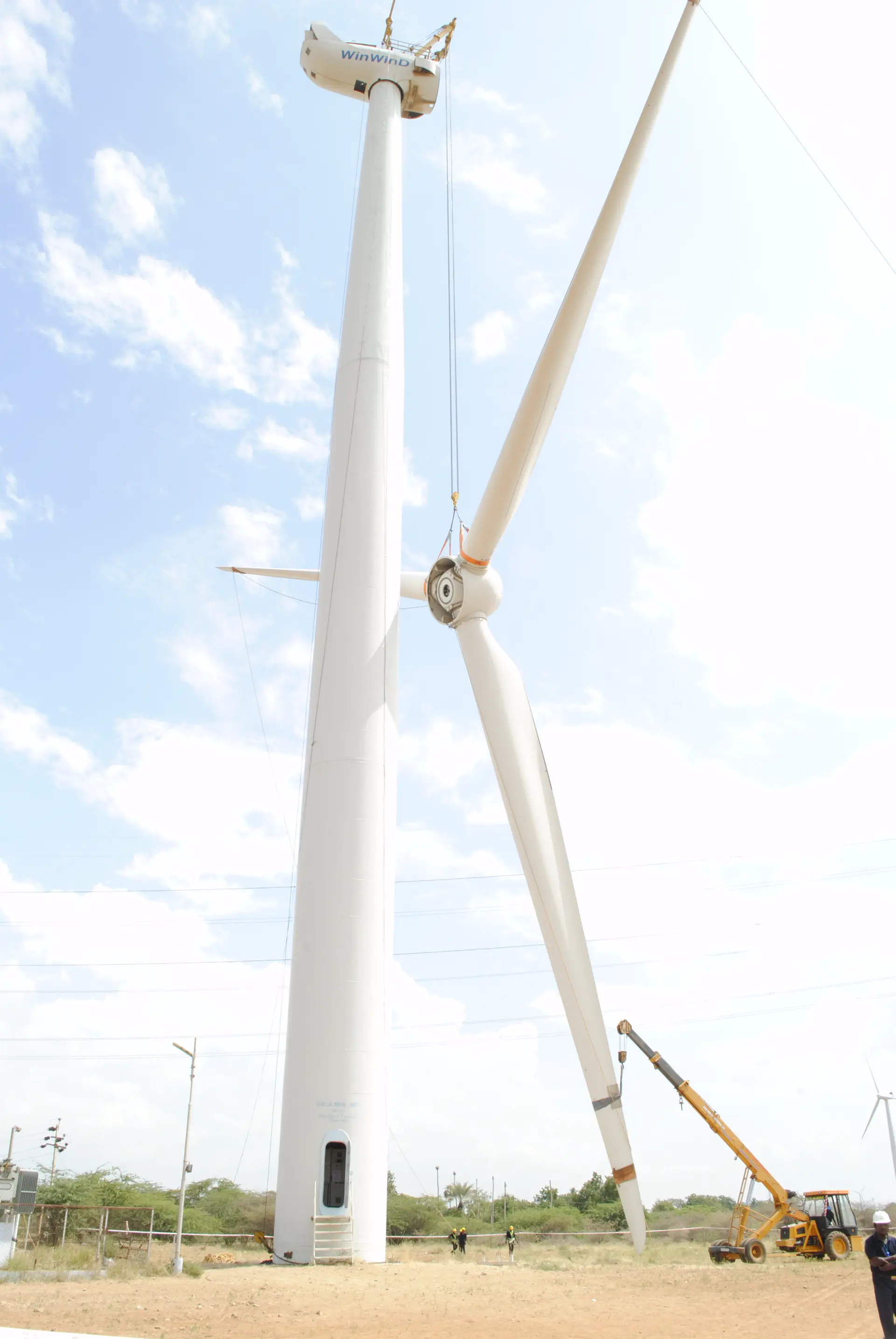Wind turbine on a lush green hill