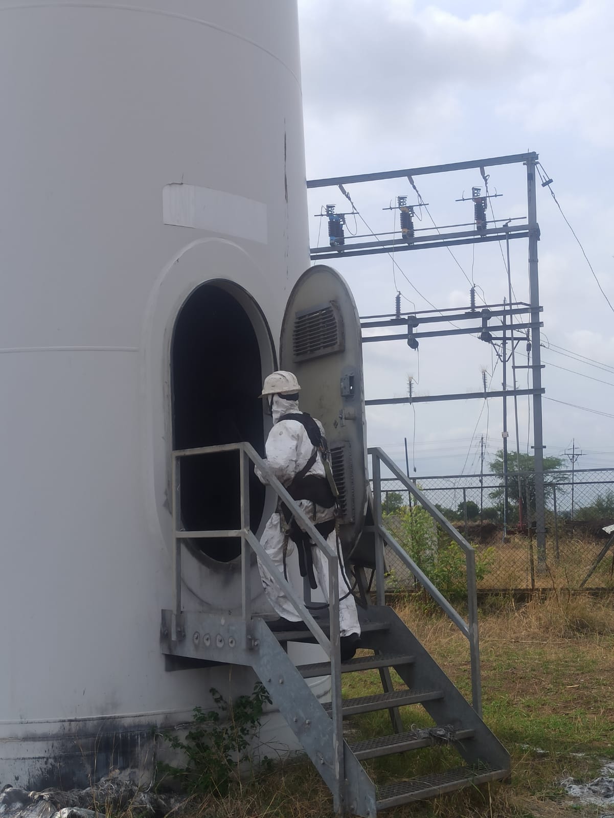 Technician inspecting wind turbine blade